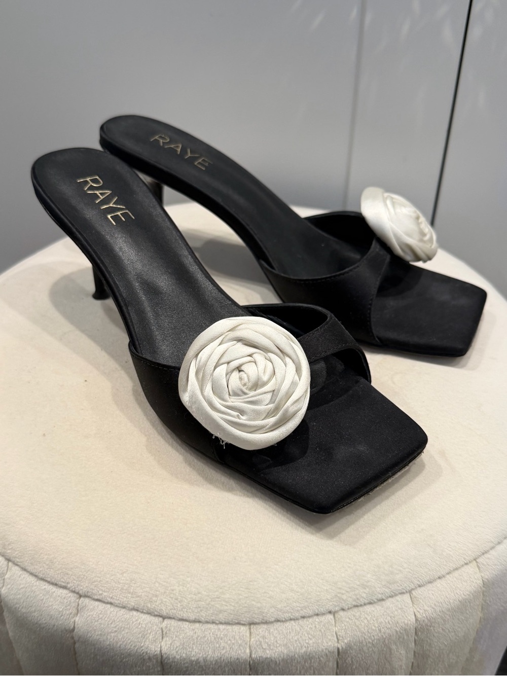 RAYE Black Satin Kitten Heels with White Rosette Accent